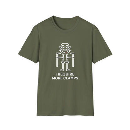 Flat lay of Clampire Halloween T-shirt. White clamp vampire graphic with text ‘I Require More Clamps’ on soft green cotton tee.