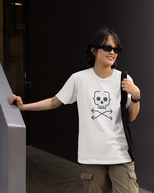Person wearing a white t-shirt with a skull and crossbones design, standing against a dark background.