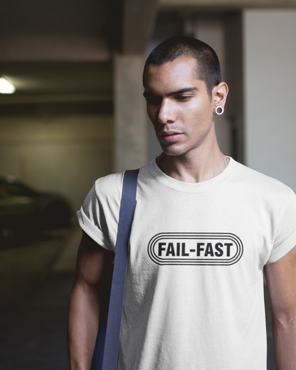 hero in white t-shirt featuring a bold retro badge logo with the text “FAIL-FAST.” Industrial design style.