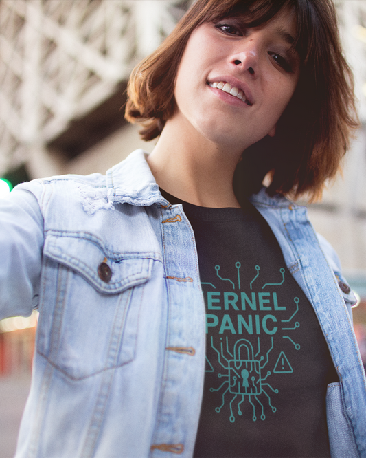 Person wearing a black t-shirt with 'KERNEL PANIC' design, standing outdoors.