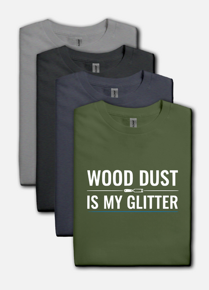 Military green t-shirt with bold white text that reads “Wood Dust Is My Glitter,” minimal graphic design.